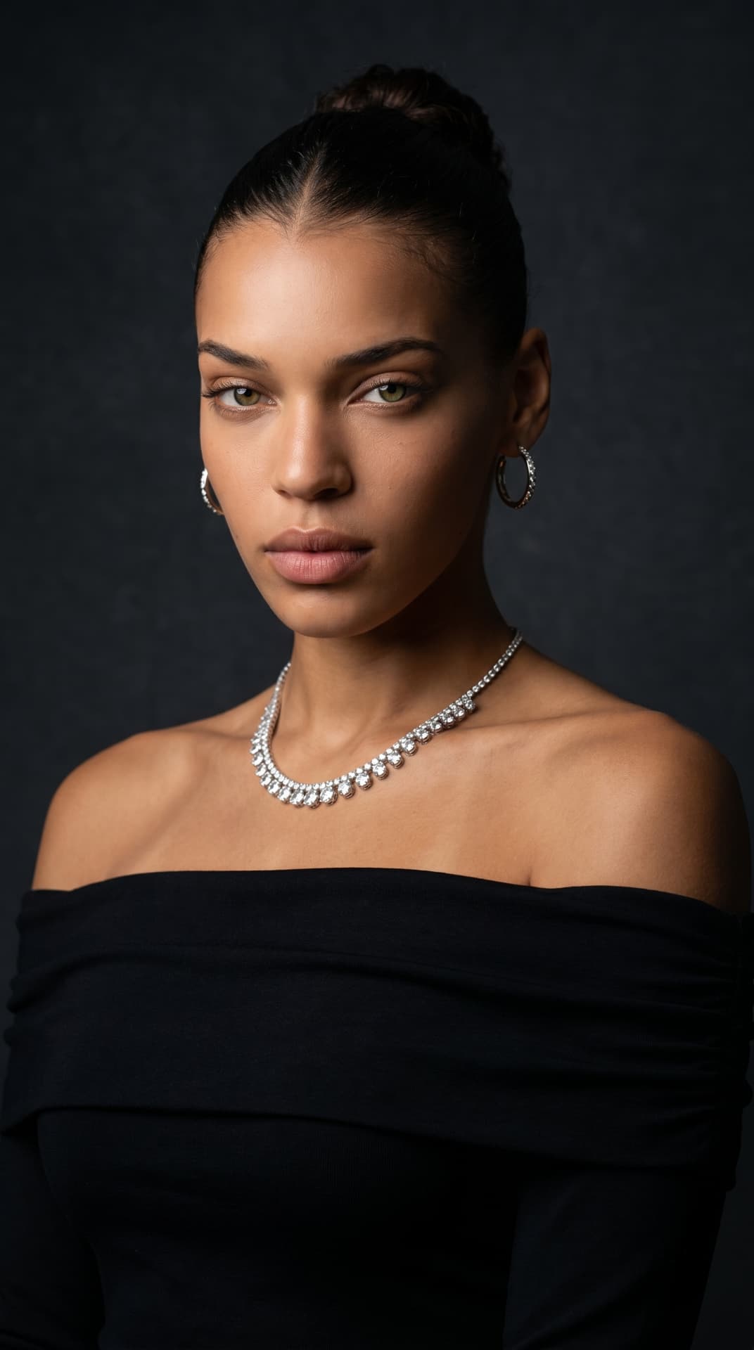 Kayda Bosse wearing a diamond necklace against a dark backdrop